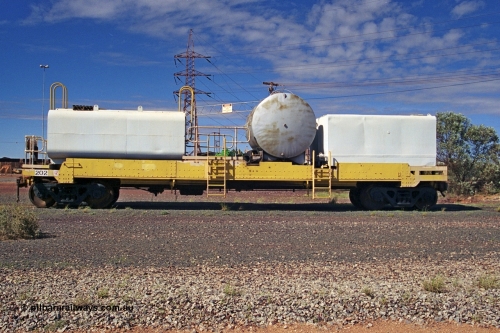 253-35
Nelson Point hard stand area, riveted flat waggon 202 with three water tanks fitted, side profile view, originally part of the 'camp train', modified by Mt Newman Mining railway workshops.
Keywords: BHP-flat-waggon;