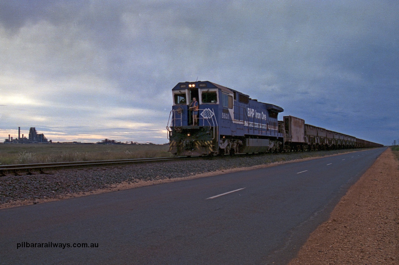 254-13
Boodarie, BHP empty train arrives back at the yard following unloading at Finucane Island behind Goninan built CM39-8 locomotive 5631 'Apollo' serial number 5831-10 / 88-080. The BHP HBI plant is in the distance on the left. September 2001.
Keywords: 5631;Goninan;GE;CM39-8;5831-10/88-080;