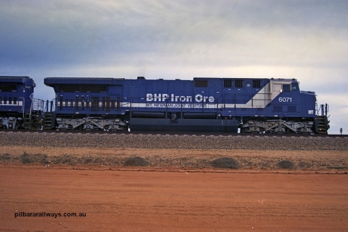 254-19
Bing Siding, an empty train awaits departure time behind 6071 an General Electric built AC6000 model with serial number 51063. The locomotive has not yet been named. Side view. September 2001.
Keywords: 6071;GE;AC6000CW;51063;
