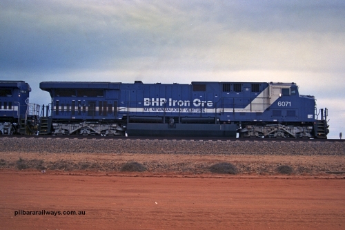 254-20
Bing Siding, an empty train awaits departure time behind 6071 an General Electric built AC6000 model with serial number 51063. The locomotive has not yet been named. Side view. September 2001.
Keywords: 6071;GE;AC6000CW;51063;