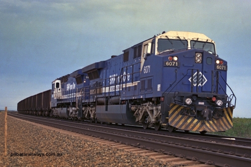 254-22
Bing Siding, an empty train awaits departure time behind 6071 an General Electric built AC6000 model with serial number 51063. The locomotive has not yet been named. Second unit is Goninan rebuilt CM40-8MEFI locomotive 5668. September 2001.
Keywords: 6071;GE;AC6000CW;51063;