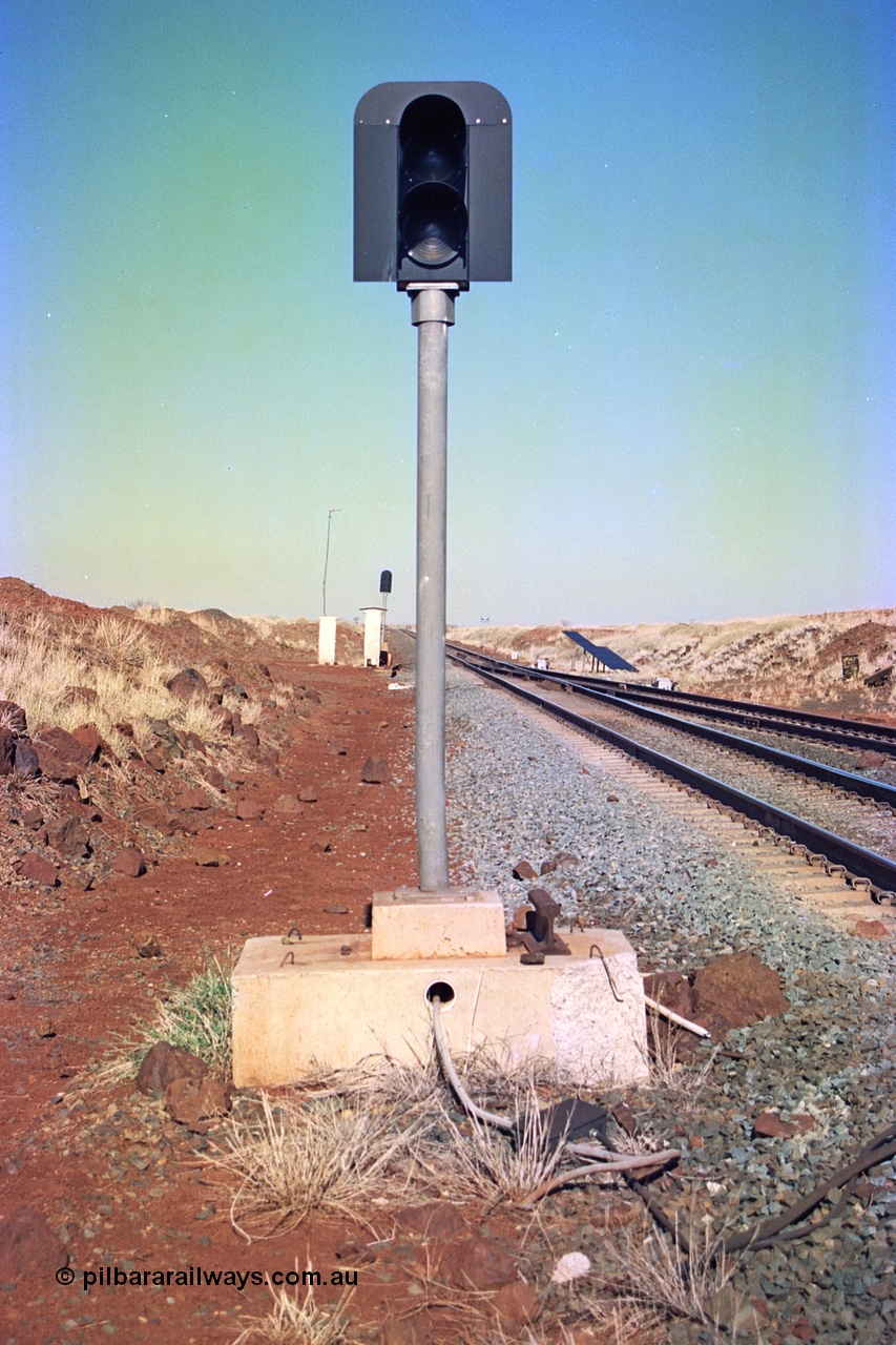 255-07
Siding Three looking south along the Cape Lambert to Deepdale mainline at the south end signal for the mainline, passing track is on the right with points in the distance. May 2002.
