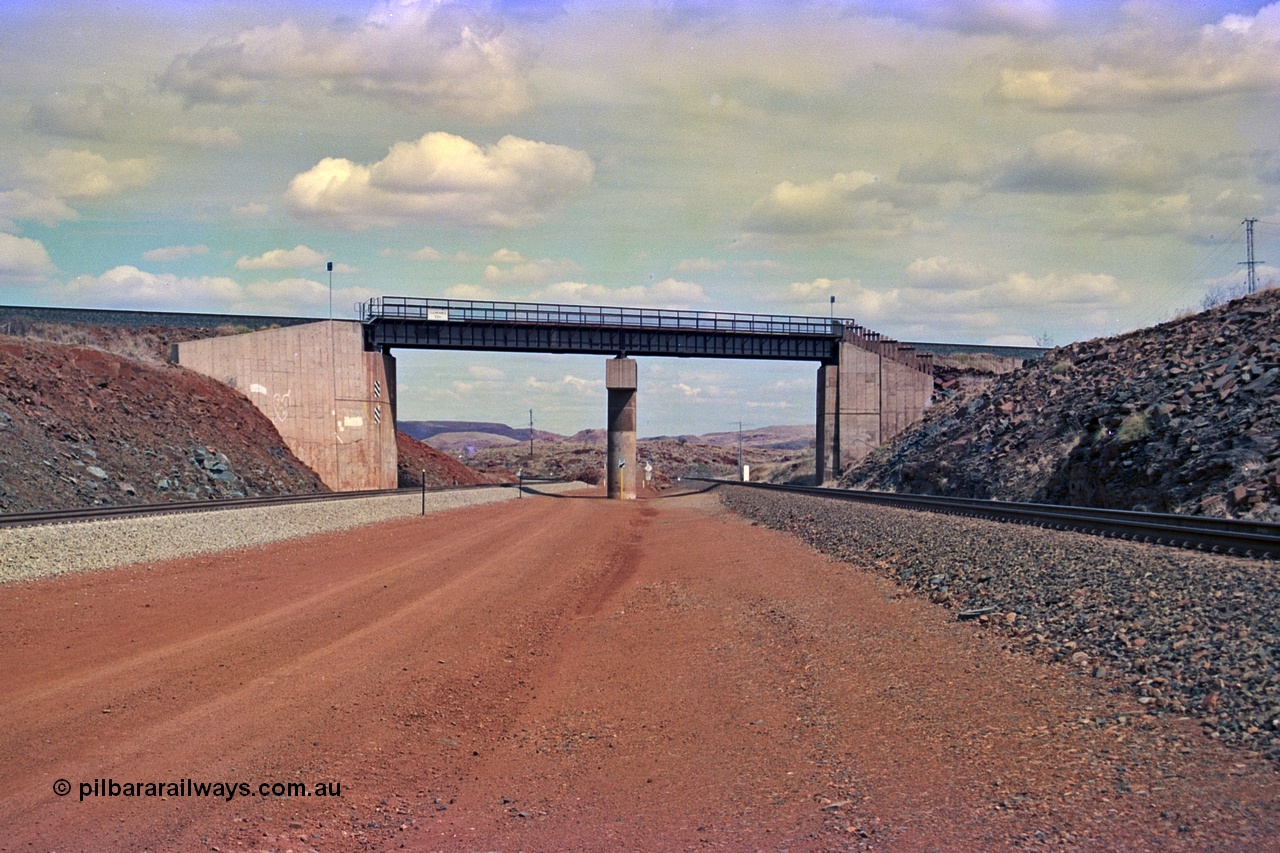 255-20
Western Creek, looking south alongside the Hamersley Iron Dampier to Tom Price line on the right with the new Robe River interconnecting line on the left as both lines pass under the Robe River Cape Lambert to Deepdale line bridge. Geodata [url=https://goo.gl/maps/ajP32PY1Zd11zPRx9]location here[/url]. May 2002.
