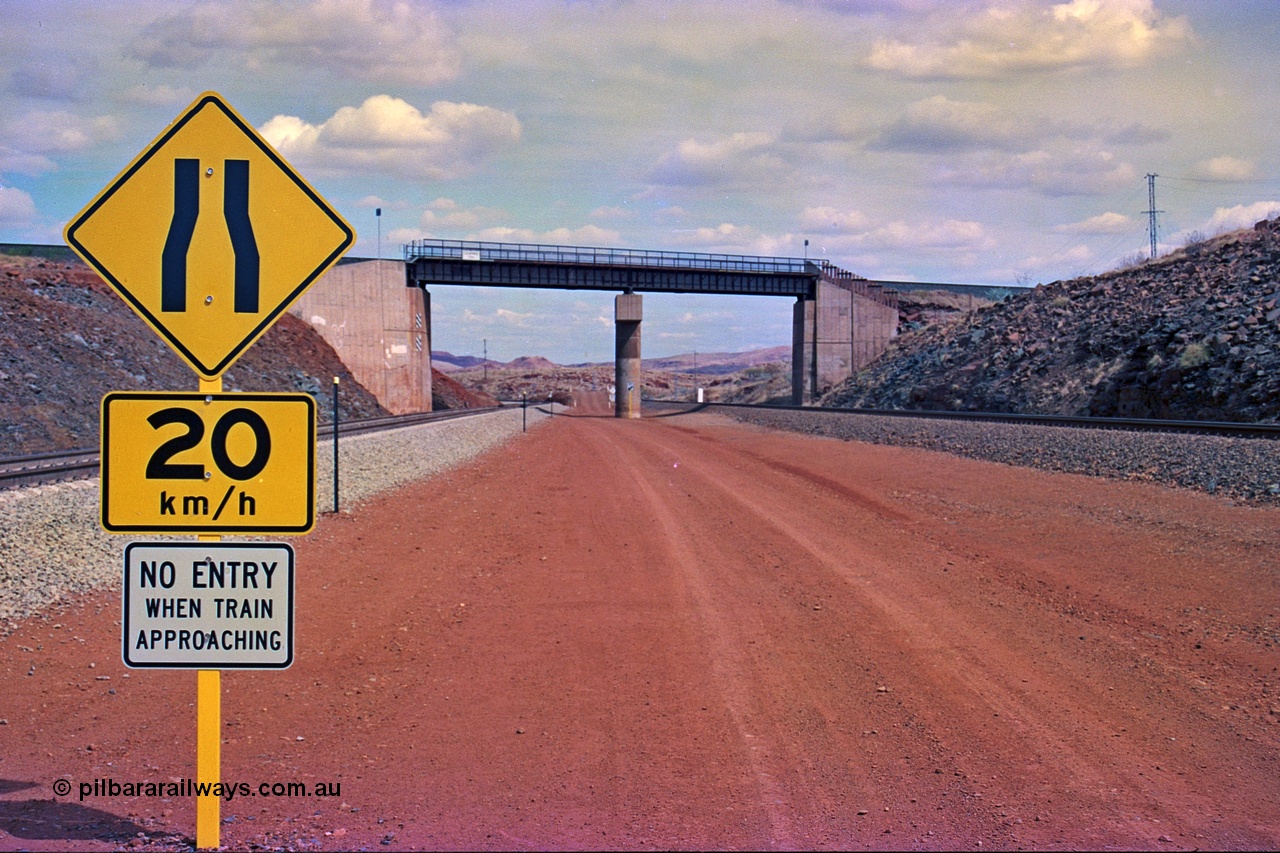 255-22
Western Creek, looking south alongside the Hamersley Iron Dampier to Tom Price line on the right with the new Robe River interconnecting line on the left as both lines pass under the Robe River Cape Lambert to Deepdale line bridge. Geodata [url=https://goo.gl/maps/ajP32PY1Zd11zPRx9]location here[/url]. May 2002.
