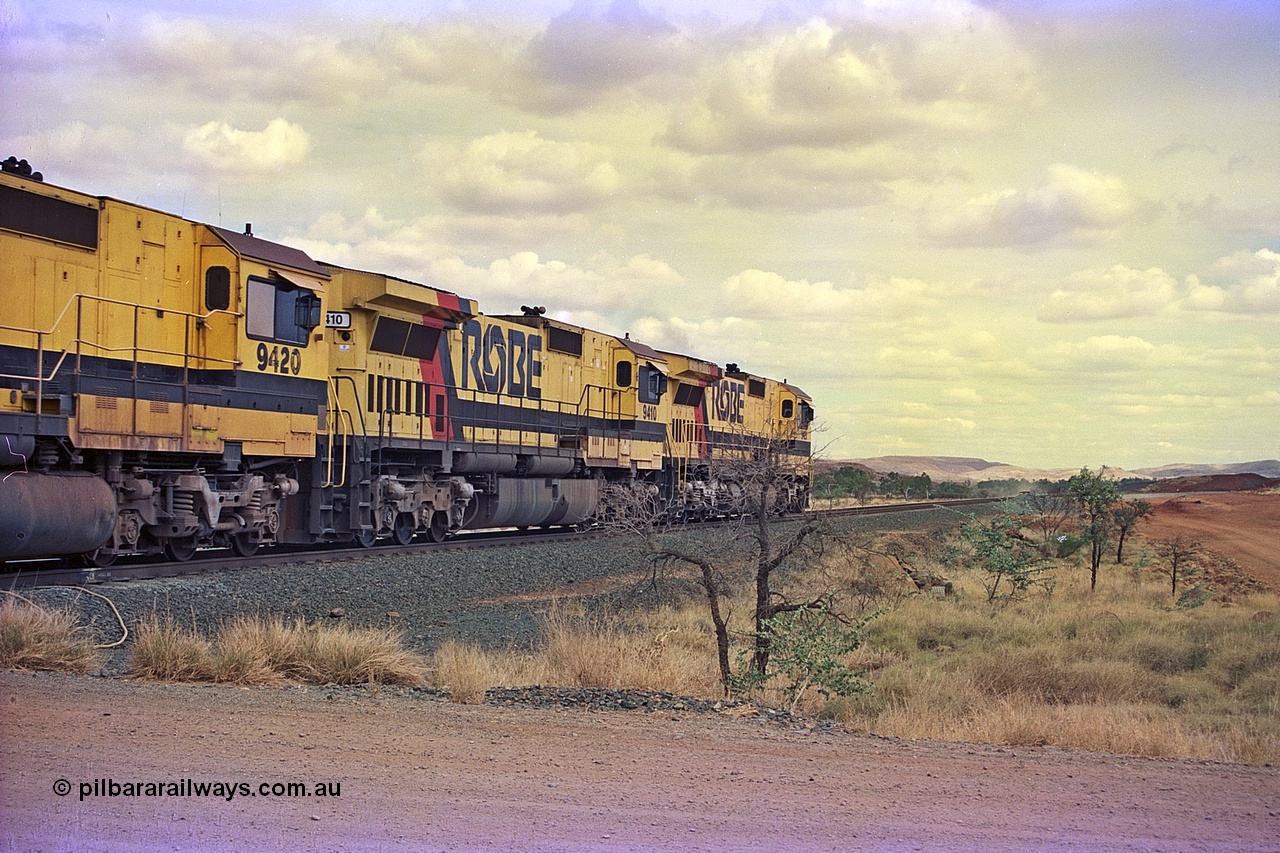 255-30
Western Creek at the 71 km on the Cape Lambert to Deepdale line an empty Robe River train powers upgrade behind the standard quad CM40-8M lash up led by Goninan CM40-8M unit 9425 and 9410 with serial number 2160-03 / 96-202. The Western Creek interconnecting line can be seen branching off to the right. Geodata [url=https://goo.gl/maps/fzacjsy5LHGwuSRg8]location here[/url]. May 2002.
Keywords: 9410;Goninan;GE;CM40-8M;2160-03/96-202;rebuild;Comeng-NSW;ALCo;M636;C-6096-5;