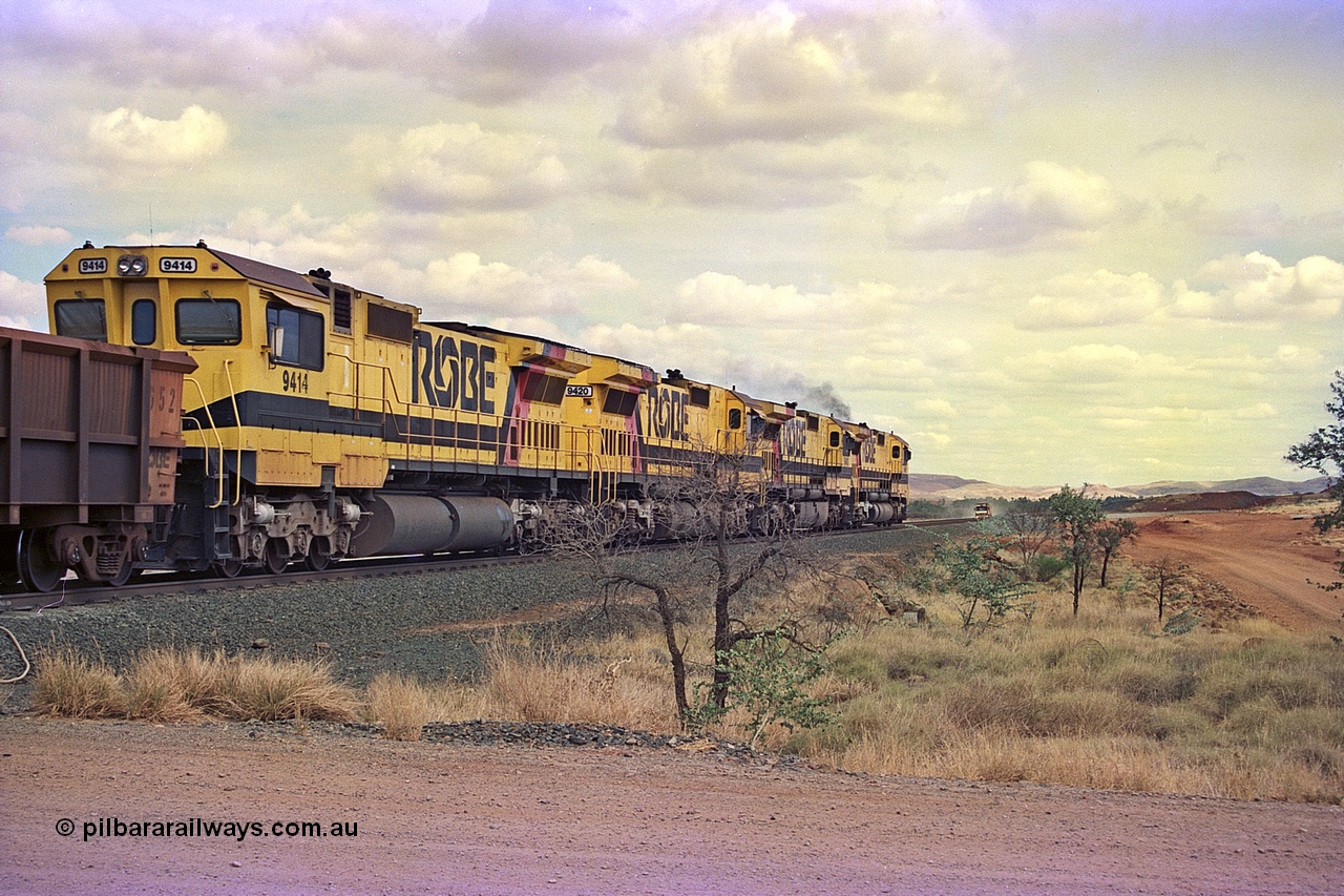 255-31
Western Creek at the 71 km on the Cape Lambert to Deepdale line an empty Robe River train powers upgrade behind the standard quad CM40-8M lash up led by Goninan CM40-8M unit 9425, 9410, 9420 and 9414 with serial number 8206-11 / 91-124. The Western Creek interconnecting line can be seen branching off to the right. Geodata [url=https://goo.gl/maps/fzacjsy5LHGwuSRg8]location here[/url]. May 2002.
Keywords: 9414;Goninan;GE;CM40-8M;8206-11/91-124;rebuild;AE-Goodwin;ALCo;M636;G6060-5;