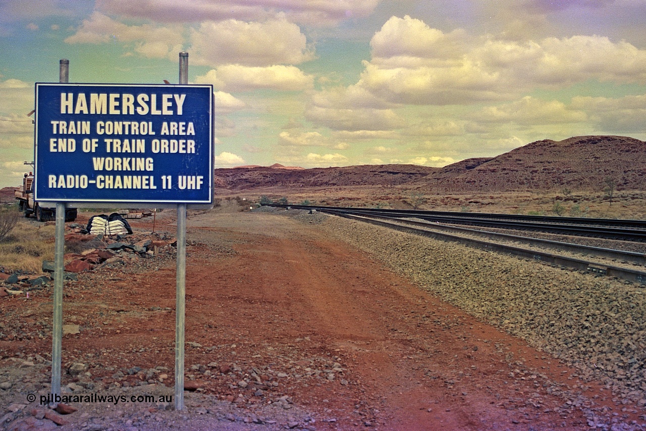 255-36
Emu Siding on the Hamersley Iron Dampier to Tom Price line with the Western Creek Robe River interconnecting line on the left joining the HI Tom Price line. Train Control board for crews to change channels. May 2002.
