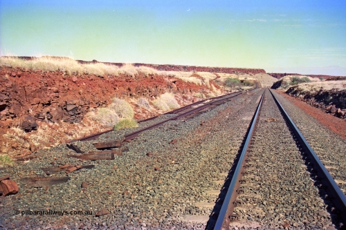 255-11
At the 162.2 km looking south are the remains of the second Robe River loadout facility which was installed in 1975 to mine the Mesa 2402E mining area, the line was a four kilometre U shaped spur. Geodata [url=https://goo.gl/maps/DATgFuHfuayyAp8y9]location here[/url]. May 2002.
