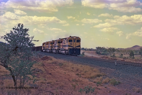 255-26
Western Creek at the 71 km on the Cape Lambert to Deepdale line an empty Robe River train powers upgrade as it heads to Mesa J for loading behind the standard quad CM40-8M lash up led by Goninan CM40-8M unit 9425 with serial number 6266-08 / 89-85 and sisters 9410, 9420 and 9414. Geodata [url=https://goo.gl/maps/fzacjsy5LHGwuSRg8]location here[/url]. May 2002.
Keywords: 9425;Goninan;GE;CM40-8M;6266-8/89-85;rebuild;AE-Goodwin;ALCo;M636;G-6041-4;