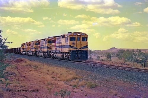 255-27
Western Creek at the 71 km on the Cape Lambert to Deepdale line an empty Robe River train powers upgrade as it heads to Mesa J for loading behind the standard quad CM40-8M lash up led by Goninan CM40-8M unit 9425 with serial number 6266-08 / 89-85 and sisters 9410, 9420 and 9414. Geodata [url=https://goo.gl/maps/fzacjsy5LHGwuSRg8]location here[/url]. May 2002.
Keywords: 9425;Goninan;GE;CM40-8M;6266-8/89-85;rebuild;AE-Goodwin;ALCo;M636;G-6041-4;