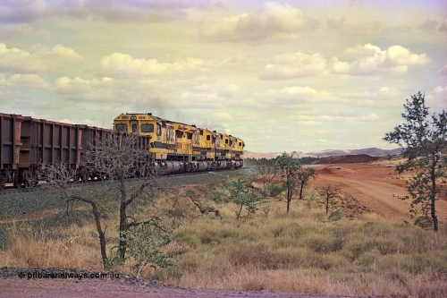 255-33
Western Creek at the 71 km on the Cape Lambert to Deepdale line an empty Robe River train powers upgrade behind the standard quad CM40-8M lash up led by Goninan CM40-8M unit 9425, 9410, 9420 and 9414 with serial number 8206-11 / 91-124. The Western Creek interconnecting line can be seen branching off to the right. Geodata [url=https://goo.gl/maps/fzacjsy5LHGwuSRg8]location here[/url]. May 2002.
Keywords: 9414;Goninan;GE;CM40-8M;8206-11/91-124;rebuild;AE-Goodwin;ALCo;M636;G6060-5;