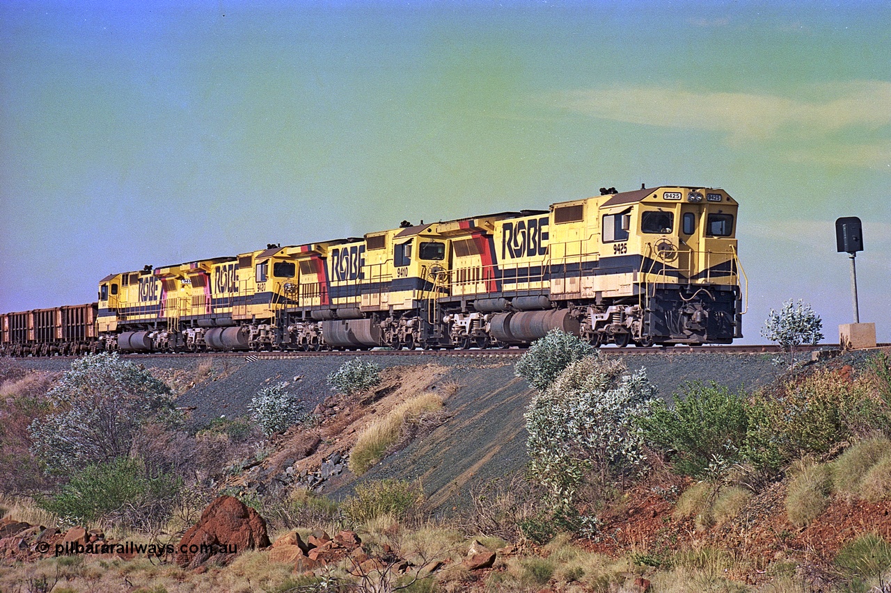 256-02
Maitland Siding on the Cape Lambert to Deepdale railway has a late afternoon empty train with the quad CM40-8M working of 9425, 9410, 9420 and 9414 in the siding waiting for a cross with an opposing loaded train. At the time of this image Siding 3 or Murray Camp was unable to cross ore trains so Siding One - Harding or Siding Two - Maitland were used. May 2002.
Keywords: 9425;Goninan;GE;CM40-8M;6266-8/89-85;rebuild;AE-Goodwin;ALCo;M636;G-6041-4;