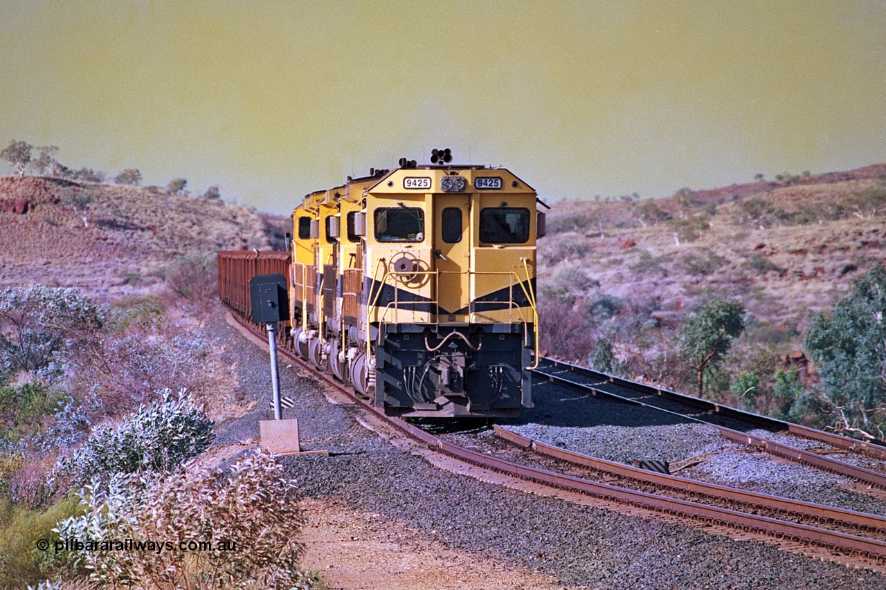 256-08
Maitland Siding on the Cape Lambert to Deepdale railway has a late afternoon empty train with the quad CM40-8M working of 9425, 9410, 9420 and 9414 in the siding waiting for a cross with an opposing loaded train. At the time of this image Siding 3 or Murray Camp was unable to cross ore trains so Siding One - Harding or Siding Two - Maitland were used. May 2002.
Keywords: 9425;Goninan;GE;CM40-8M;6266-8/89-85;rebuild;AE-Goodwin;ALCo;M636;G-6041-4;