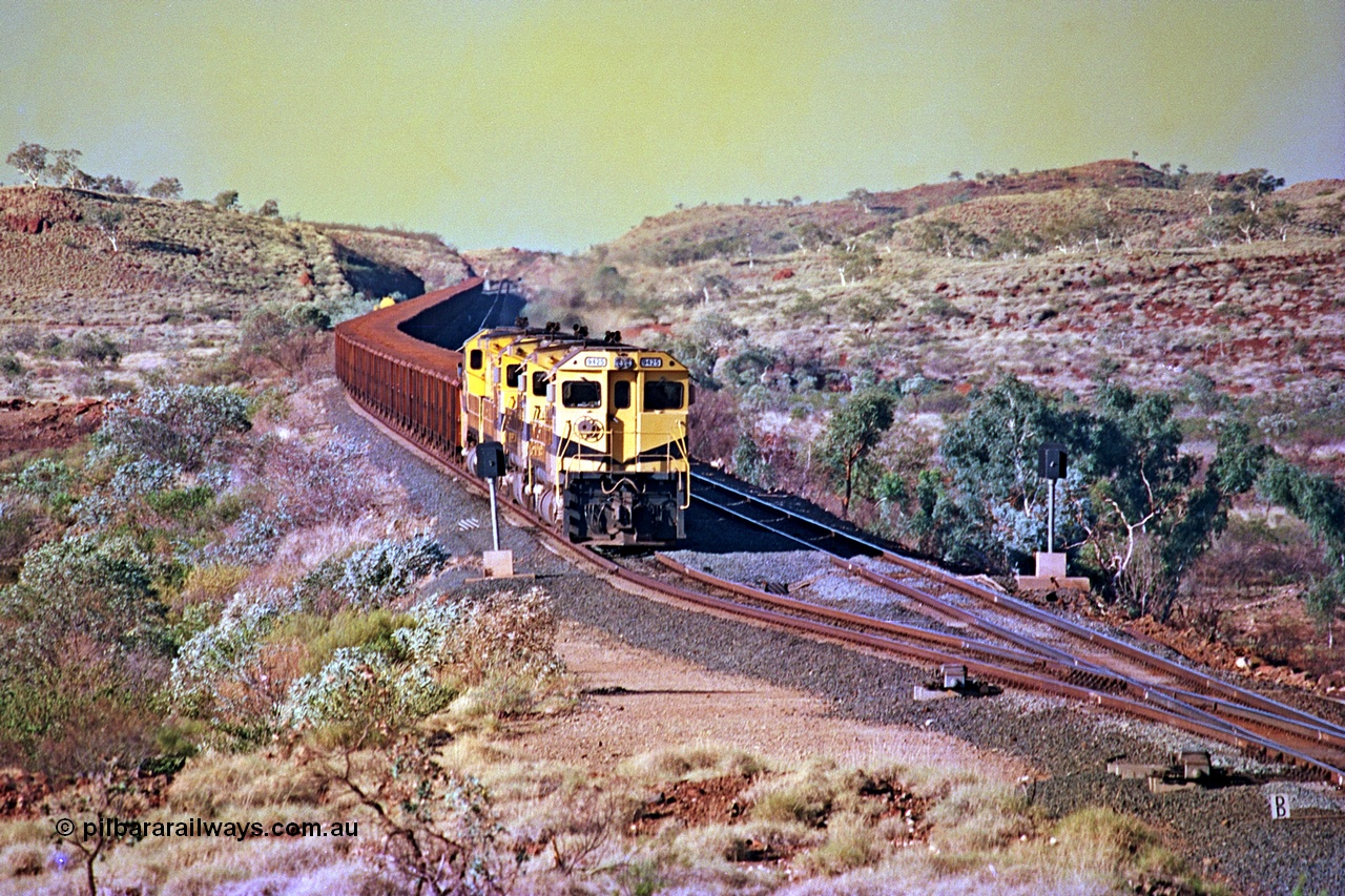 256-12
Maitland Siding on the Cape Lambert to Deepdale railway has a late afternoon empty train with the quad CM40-8M working of 9425, 9410, 9420 and 9414 in the siding waiting for a cross with an opposing loaded train. At the time of this image Siding 3 or Murray Camp was unable to cross ore trains so Siding One - Harding or Siding Two - Maitland were used. May 2002.
Keywords: 9425;Goninan;GE;CM40-8M;6266-8/89-85;rebuild;AE-Goodwin;ALCo;M636;G-6041-4;