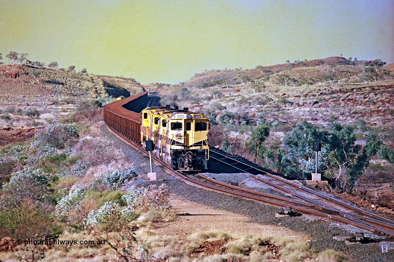 256-13
Maitland Siding on the Cape Lambert to Deepdale railway has a late afternoon empty train with the quad CM40-8M working of 9425, 9410, 9420 and 9414 in the siding waiting for a cross with an opposing loaded train. At the time of this image Siding 3 or Murray Camp was unable to cross ore trains so Siding One - Harding or Siding Two - Maitland were used. May 2002.
Keywords: 9425;Goninan;GE;CM40-8M;6266-8/89-85;rebuild;AE-Goodwin;ALCo;M636;G-6041-4;