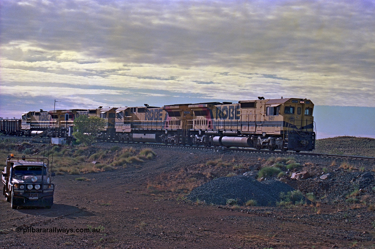 256-21
Maitland Siding, morning empty train arriving into the passing track behind quad CM40-8M working of 9417, 9433, 9418 and 9419. May 2002.
Keywords: 9417;Goninan;GE;CM40-8M;6266-5/89-83;rebuild;ALCo;Schenectady-NY;C636;BN4366;6010-1;