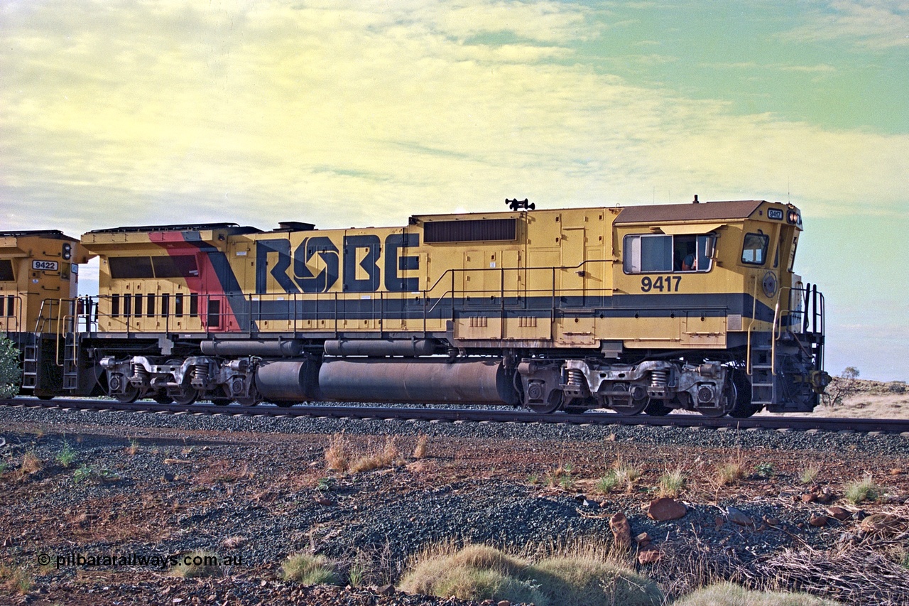 256-22
Maitland Siding, Robe River CM40-8M unit 9417 (2nd) leading an empty train into the passing track. 9417 was the first CM40-8M rebuild carried out by Goninan in 1989, it was originally an ALCo built C636 unit for Spokane Portland & Seattle numbered 340 with serial number 6010-1, it went onto to be Burlington Northern 4366 and then purchased for Robe River in late 1980 as a parts source. When finally rebuilt by Goninan in June 1989 it had new serial number of 6266-5 / 89-83 and replaced the original 9417 which was scrapped in 1979. May 2002.
Keywords: 9417;Goninan;GE;CM40-8M;6266-5/89-83;rebuild;ALCo;Schenectady-NY;C636;BN4366;6010-1;