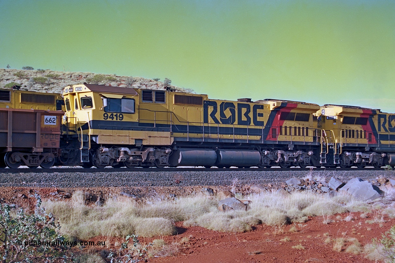 256-27
Maitland Siding, Robe River CM40-8M unit 9419 on an empty train. 9419 was built by ALCo Schenectady NY USA as an ALCo C630 model in October 1967 with serial number 3486-03 for the Chesapeake and Ohio Railroad Company (USA) with road number 2102. It was purchased by Morrison Knudsen for Robe River (along with three sister units) and delivered in January 1975 and repainted and renumbered as 9419 on arrival. 9419 was rebuilt by Goninan WA in October 1990 to become an CM40-8M model with serial number 8109-10 / 90-117. May 2002.
Keywords: 9419;Goninan;GE;CM40-8M;8109-10/90-117;rebuild;ALCo;Schenectady-NY;C630;C+O2102;3486-3;