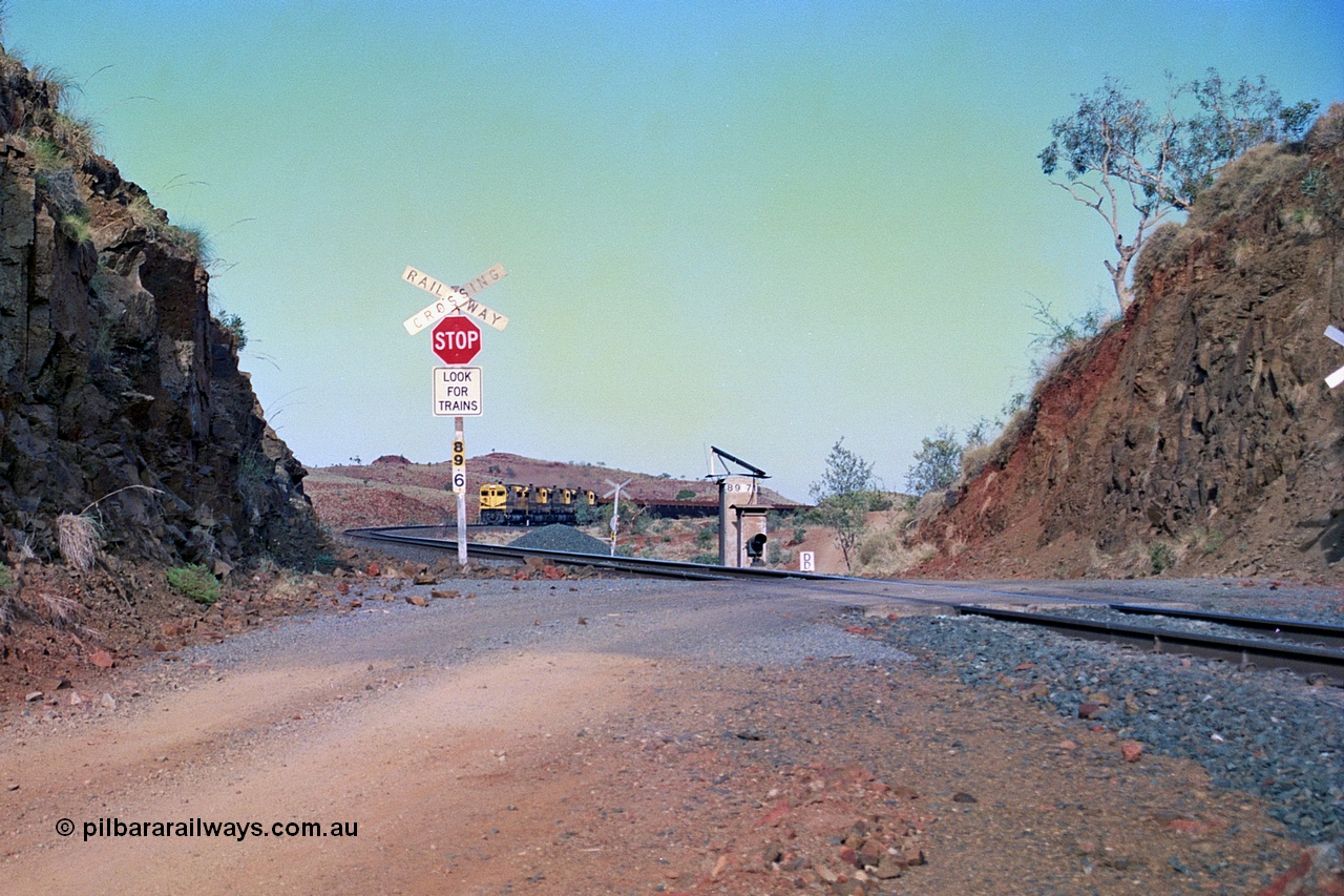 256-28
At the 89.6 km grade crossing and with the meet at Maitland completed the loaded train continues onto Cape Lambert behind the quad CM40-8M working. May 2002.
Keywords: 9414;Goninan;GE;CM40-8M;8206-11/91-124;rebuild;AE-Goodwin;ALCo;M636;G6060-5;