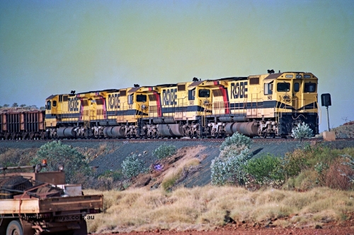 256-11
Maitland Siding on the Cape Lambert to Deepdale railway has a late afternoon empty train with the quad CM40-8M working of 9425, 9410, 9420 and 9414 in the siding waiting for a cross with an opposing loaded train. At the time of this image Siding 3 or Murray Camp was unable to cross ore trains so Siding One - Harding or Siding Two - Maitland were used. May 2002.
Keywords: 9425;Goninan;GE;CM40-8M;6266-8/89-85;rebuild;AE-Goodwin;ALCo;M636;G-6041-4;