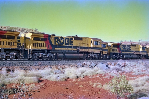 256-24
Maitland Siding, Robe River CM40-8M unit 9417 (2nd) leading an empty train passes sister units 9420 and 9410 on a loaded train. May 2002.
Keywords: 9417;Goninan;GE;CM40-8M;6266-5/89-83;rebuild;ALCo;Schenectady-NY;C636;BN4366;6010-1;
