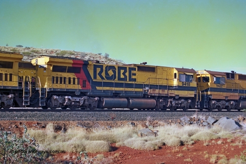 256-26
Maitland Siding, Robe River CM40-8M unit 9418 on an empty train. 9418 was built by ALCo Schenectady NY USA as an ALCo C630 model in October 1967 with serial number 3486-02 for the Chesapeake and Ohio Railroad Company (USA) with road number 2101. It was purchased by Morrison Knudsen for Robe River (along with three sister units) and delivered in January 1975 and repainted and renumbered as 9418 on arrival. 9418 was rebuilt by Goninan WA in December 1990 to become an CM40-8M model with serial number 8109-12 / 90-118. May 2002.
Keywords: 9418;Goninan;GE;CM40-8M;8109-12/90-118;rebuild;ALCo;Schenectady-NY;C630;C+O2101;3486-2;