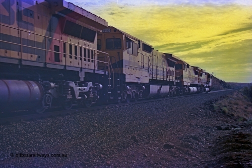256-35
At the 89.6 km grade crossing the loaded train behind the quad CM40-8M working of 9414, 9420, 9410 and 9425 rolls across the crossing and heads down the 1.26 percent grade. 9410 (2nd) was built by Comeng NSW as an ALCo M636 model in November 1975 with serial number C6098-05 for Mount Neman Mining with road number 5500, it was sent to Goninan but not rebuilt. Eventually sold to Robe and rebuilt by Goninan WA to an CM40-8M model in March 1996 with serial number 2160-03/96-202. May 2002.
Keywords: 9410;Goninan;GE;CM40-8M;2160-03/96-202;rebuild;Comeng-NSW;ALCo;M636;C-6096-5;