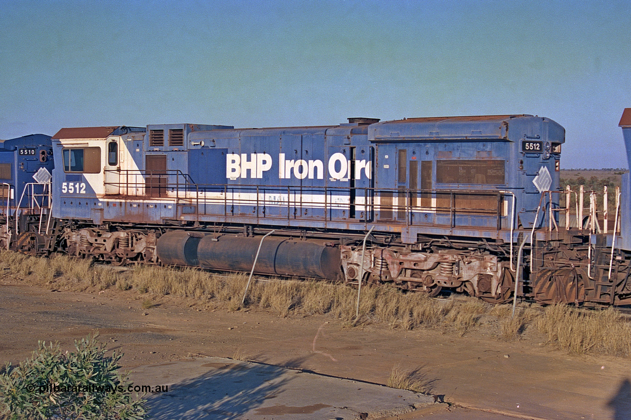 257-05
Flash Butt yard BHP's stored Goninan WA ALCo C636 to GE C36-7M rebuild unit 5512 awaits its fate. Rebuilt in 1988 at Goninan's Welshpool factory from a 1970 AE Goodwin built ALCo C636 with serial number G6041-1 and road number 5455 and assigned new serial number 4839-01 / 88-077. It was delivered in Mount Newman Mining orange and was named Hesta. Late 2001.
Keywords: 5512;Goninan;GE;C36-7M;4839-01/88-077;rebuild'AE-Goodwin;ALCo;C636;5465;G6041-1;