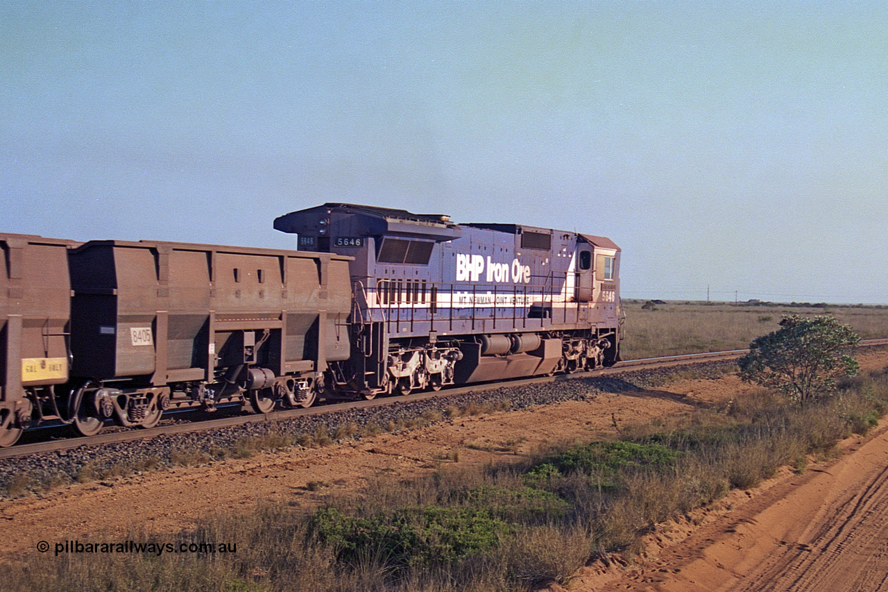 257-26
Goldsworthy Junction, an empty train runs between the junction and the Broome Rd crossing behind the standard single locomotive 5646 'White Springs', a Goninan 1992 built GE CM40-8 model with serial number 5244-11 / 92-135, one of a pair of new build locos financed by Goldsworthy. Late 2001.
Keywords: 5646;Goninan;GE;CM40-8;8244-11/92-135;