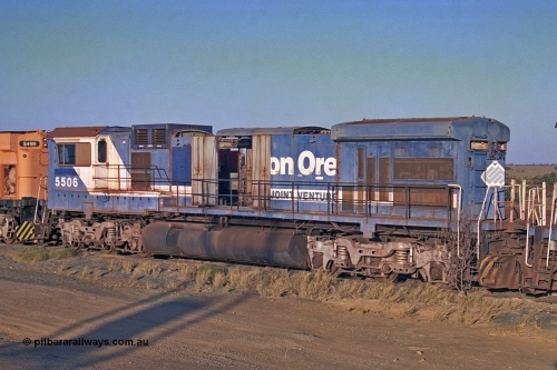 257-07
Flash Butt yard BHP's stored Goninan WA ALCo C636 to GE C36-7M rebuild unit 5506 awaits its fate. Rebuilt in 1987 at Goninan's Welshpool factory from a 1968 AE Goodwin built ALCo C636 with serial number G6012-4 and road number 5455 and assigned new serial number 4839-01 / 87-071. It was delivered in Mount Newman Mining orange and was named Mt Goldsworthy. 5506 was the first unit in the world where an ALCo C636 had been rebuilt into an GE C36-7. Late 2001.
Keywords: 5506;Goninan;GE;C36-7M;4839-01/87-071;rebuild;AE-Goodwin;ALCo;C636;5455;G6012-4;