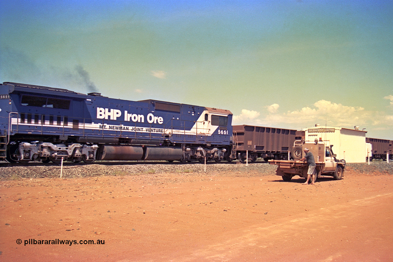 267-12
Goldsworthy Junction, BHP's 1230 empty departure mid-train unit Goninan rebuild CM40-8M GE units 5651 'Tobata' serial number 8412-08 / 93-142 104 waggons from the lead passes the Goldsworthy Junction relay room as Pope reads the newspaper. 1247 hrs Friday 12th of April 2002.
Keywords: 5651;Goninan;GE;CM40-8M;8412-08/93-142;rebuild;AE-Goodwin;ALCo;M636C;5472;G6047-4;