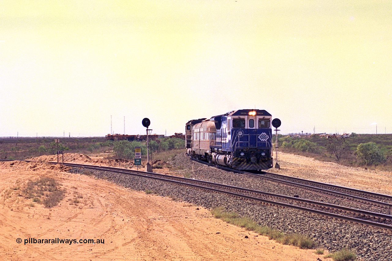 267-18
Goldsworthy Junction, the Sundowner Special is on the Newman mainline leg of the Goldsworthy Junction and triangle, with the Sundowner coach in between CM40-8M GE unit 5634 'Boodarie' serial number 8151-07 / 91-120 and sister CM40-8M 5653. This train, and the empty before it, were delayed due to a jamming switch for the transfer road where Tamper 2 and Ballast Regulator 31 can be seen holding track. The road curving around to the left is the Goldsworthy mainline to Boodarie and Finucane Island. Friday 12th of April 2002.
Keywords: 5634;Goninan;GE;CM40-8M;8151-07/91-120;rebuild;AE-Goodwin;ALCo;C636;5457;G6027-1;