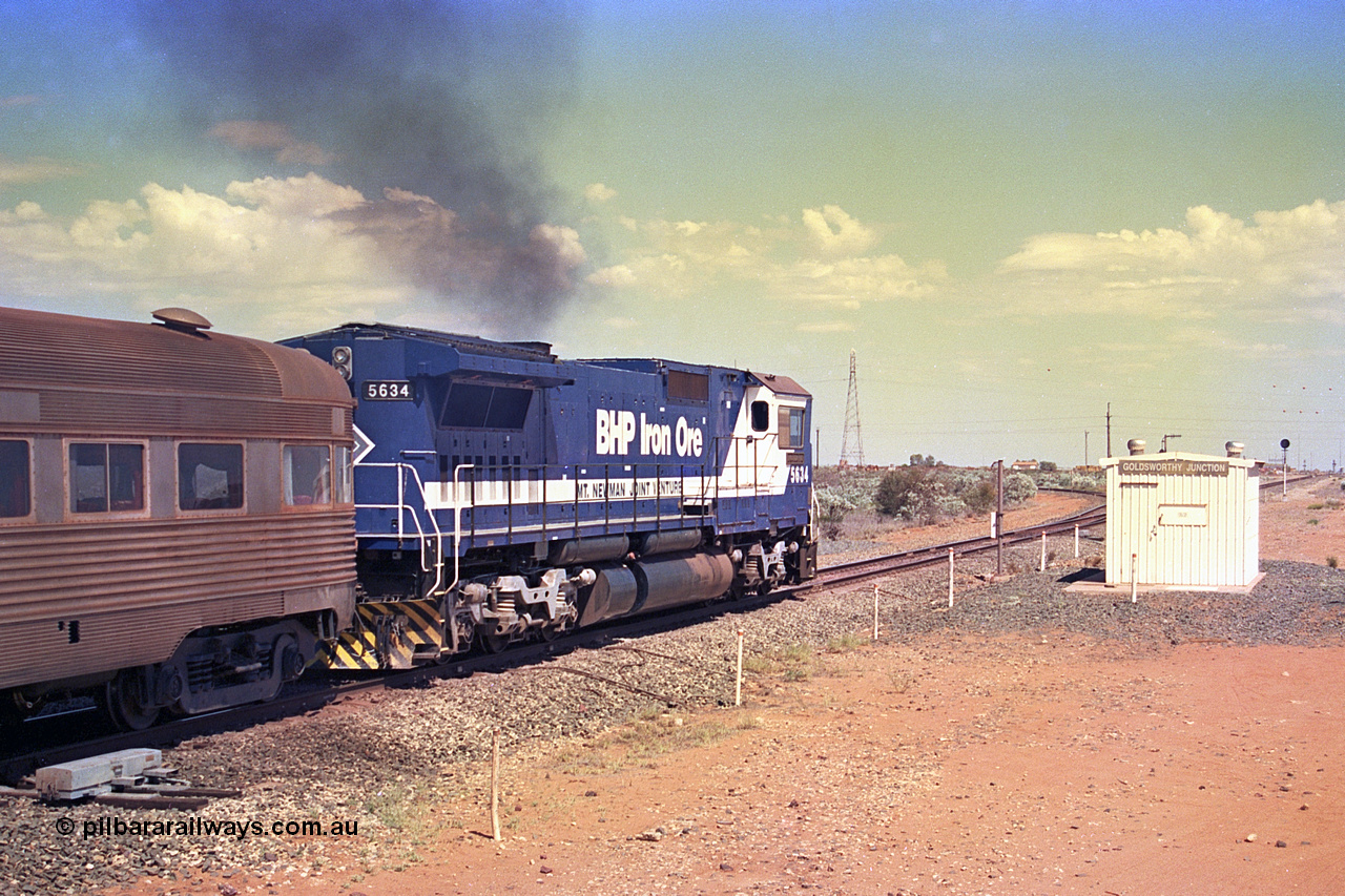 267-21
Goldsworthy Junction, CM40-8M GE rebuild unit 5634 'Boodarie' serial number 8151-07 / 91-120 turns on the power as it passes Goldsworthy Junction relay room and continues along the Newman Mainline with the Sundowner and sister unit 5653. The realigned former Goldsworthy line to the Yarrie and Nimingarra mines can be seen curving away to the left in front of 5634. Friday 12th of April 2002.
Keywords: 5634;Goninan;GE;CM40-8M;8151-07/91-120;rebuild;AE-Goodwin;ALCo;C636;5457;G6027-1;