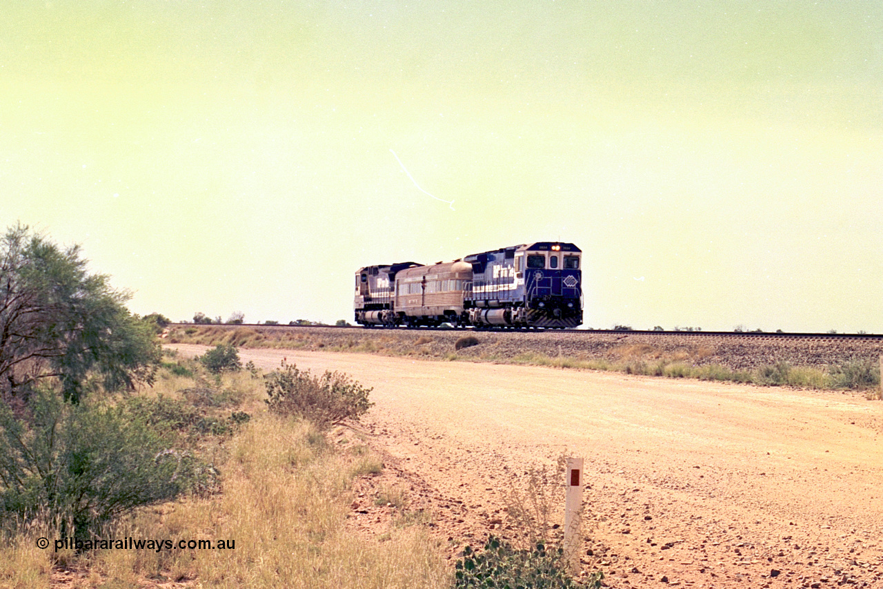 267-25
On approach to the 39 km Detector Site the Sundowner Special runs along the Newman Mainline behind BHP Iron Ore's Goninan rebuild CM40-8M unit 5634 'Boodarie' serial number 8151-07 / 91-120 with sister 5653 on the rear. Friday 12th of April 2002.
Keywords: 5634;Goninan;GE;CM40-8M;8151-07/91-120;rebuild;AE-Goodwin;ALCo;C636;5457;G6027-1;