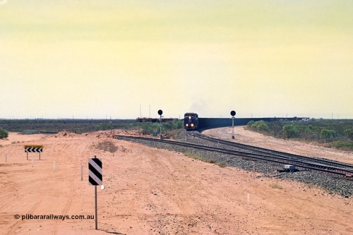 267-03
Goldsworthy Junction, BHP's 1230 empty departure behind General Electric AC6000 unit 6076 'Mt Goldsworthy' serial number 51068 leads CM40-8MEFI 5669 on the point with mid-train units CM40-8M units 5651 and 5645 104 waggons back with 104 waggons trailing. 1247 hrs April 12, 2002.
Keywords: 6076;GE;AC6000CW;51068;
