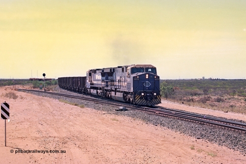 267-05
Goldsworthy Junction, BHP's 1230 empty departure behind General Electric AC6000 unit 6076 'Mt Goldsworthy' serial number 51068 leads CM40-8MEFI 5669 on the point with mid-train units CM40-8M units 5651 and 5645 104 waggons back with 104 waggons trailing. 1247 hrs April 12, 2002.
Keywords: 6076;GE;AC6000CW;51068;