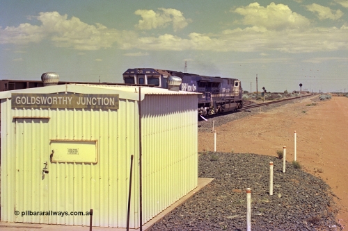 267-08
Goldsworthy Junction, BHP's 1230 empty departure behind General Electric AC6000 unit 6076 'Mt Goldsworthy' serial number 51068 leads CM40-8MEFI 5669 on the point with two CM40-8M mid-train units an 208 waggons powers along the Newman mainline with the Goldsworthy line to Yarrie curving away directly in front of 6076. 1247 hrs April 12, 2002.
Keywords: 6076;GE;AC6000CW;51068;