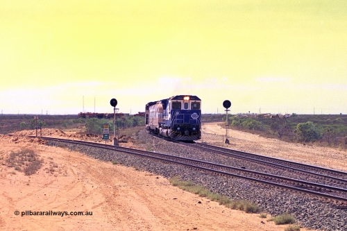 267-17
Goldsworthy Junction, the Sundowner Special is on the Newman mainline leg of the Goldsworthy Junction and triangle, with the Sundowner coach in between CM40-8M GE unit 5634 'Boodarie' serial number 8151-07 / 91-120 and sister CM40-8M 5653. This train, and the empty before it, were delayed due to a jamming switch for the transfer road where Tamper 2 and Ballast Regulator 31 can be seen holding track. The road curving around to the left is the Goldsworthy mainline to Boodarie and Finucane Island. Friday April 12, 2002.
Keywords: 5634;Goninan;GE;CM40-8M;8151-07/91-120;rebuild;AE-Goodwin;ALCo;C636;5457;G6027-1;