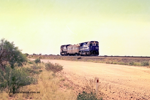 267-25
On approach to the 39 km Detector Site the Sundowner Special runs along the Newman Mainline behind BHP Iron Ore's Goninan rebuild CM40-8M unit 5634 'Boodarie' serial number 8151-07 / 91-120 with sister 5653 on the rear. Friday April 12, 2002.
Keywords: 5634;Goninan;GE;CM40-8M;8151-07/91-120;rebuild;AE-Goodwin;ALCo;C636;5457;G6027-1;