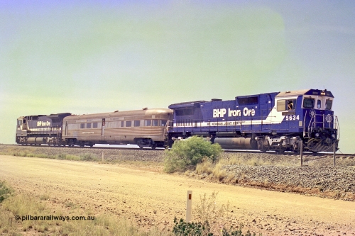 267-28
39 km Newman line, Goninan rebuild CM40-8M unit 5634 'Boodarie' serial number 8151-07 / 91-120 slows as it brings the Sundowner special to a stop at the 39 km detector site on the Newman mainline. The trailing unit is 5653. This was a special for the 25 years of the Alstom / BHP service agreement. Friday April 12, 2002.
Keywords: 5634;Goninan;GE;CM40-8M;8151-07/91-120;rebuild;AE-Goodwin;ALCo;C636;5457;G6027-1;