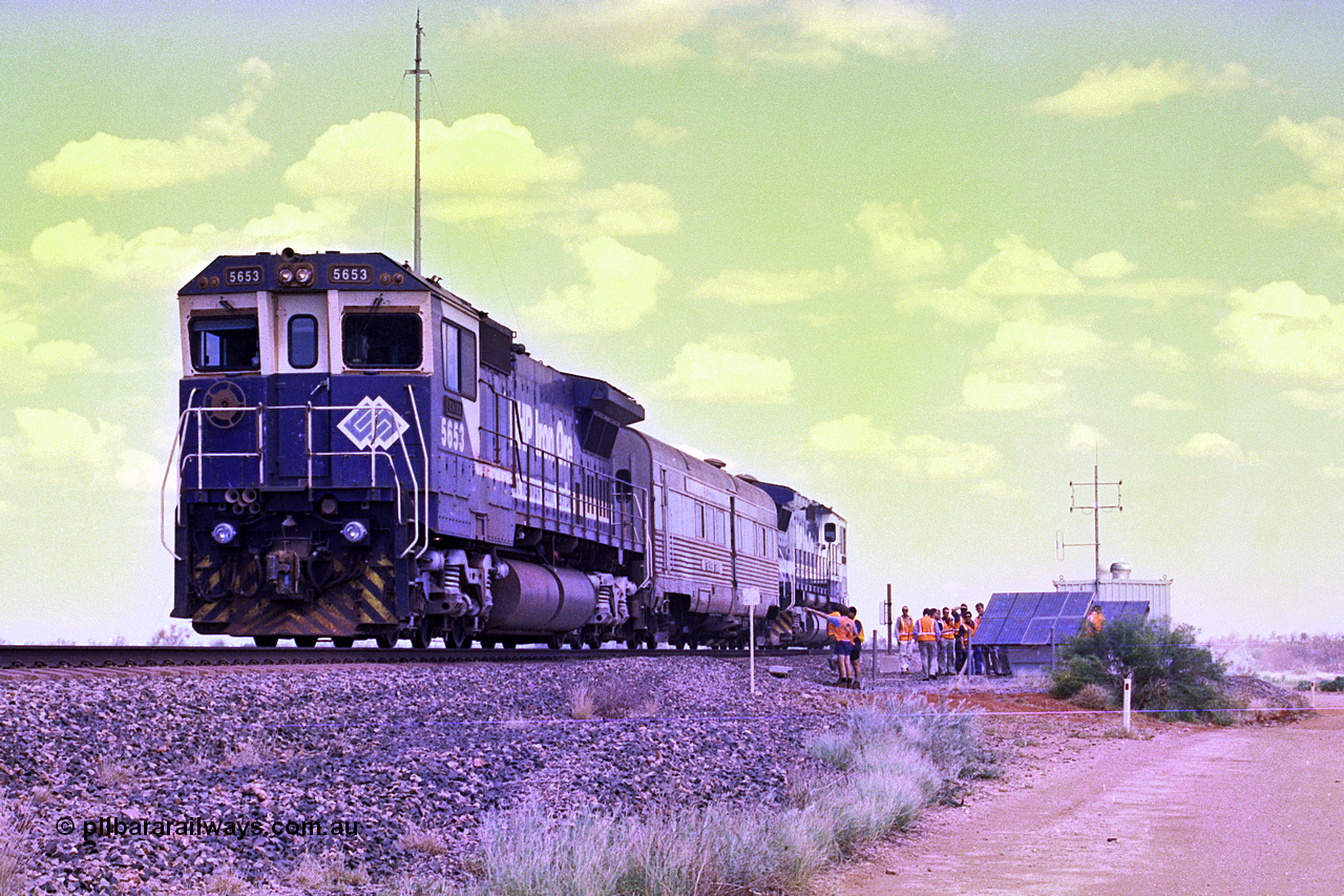 268-04
At the 39 km detection site with the Alstom 25-year service agreement special, BHP Iron Ore's Goninan GE rebuild CM40-8M unit 5653 'Chiba' serial number 8412-10 / 93-144 stands on the Newman mainline with The Sundowner and 5634 on the rear of the train as the party conducts an inspection of the site. Friday 12th of April 2002.
Keywords: 5653;Goninan;GE;CM40-8M;8412-10/93-144;rebuild;AE-Goodwin;ALCo;M636C;5484;G6061-5;