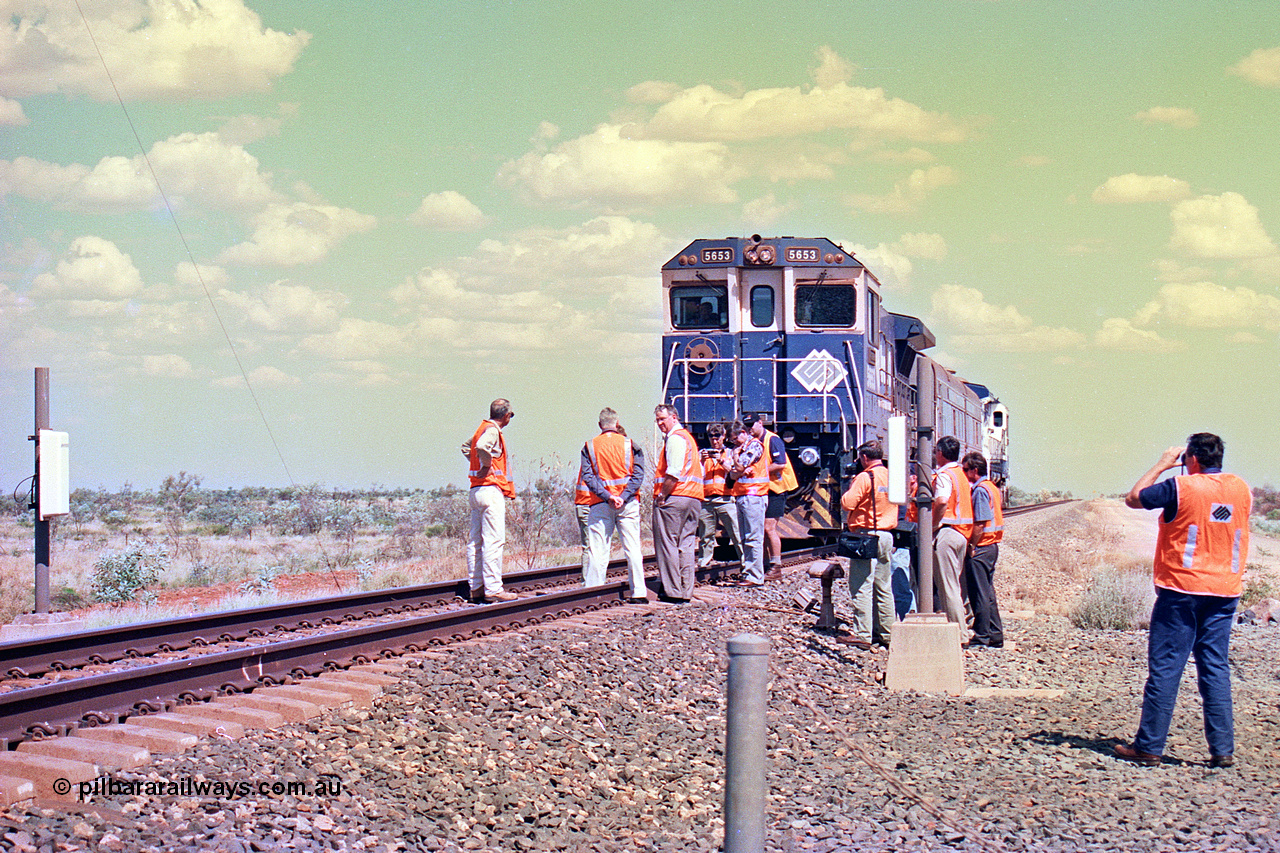 268-26
At the 39 km detection site with the Alstom 25-year service agreement special, BHP Iron Ore's Goninan GE rebuild CM40-8M unit 5653 'Chiba' serial number 8412-10 / 93-144 stands on the Newman mainline with The Sundowner and 5634 on the rear of the train as the party conducts an inspection of the site. Friday 12th of April 2002.
Keywords: 5653;Goninan;GE;CM40-8M;8412-10/93-144;rebuild;AE-Goodwin;ALCo;M636C;5484;G6061-5;