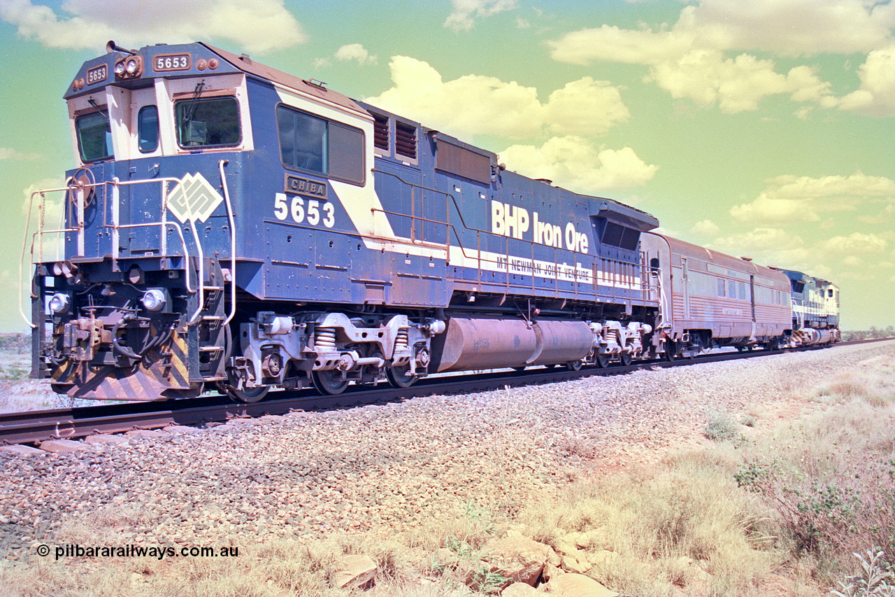 268-27
At the 39 km detection site with the Alstom 25-year service agreement special, BHP Iron Ore's Goninan GE rebuild CM40-8M unit 5653 'Chiba' serial number 8412-10 / 93-144 stands on the Newman mainline with The Sundowner and 5634 on the rear of the train as the party conducts an inspection of the site. Friday 12th of April 2002.
Keywords: 5653;Goninan;GE;CM40-8M;8412-10/93-144;rebuild;AE-Goodwin;ALCo;M636C;5484;G6061-5;