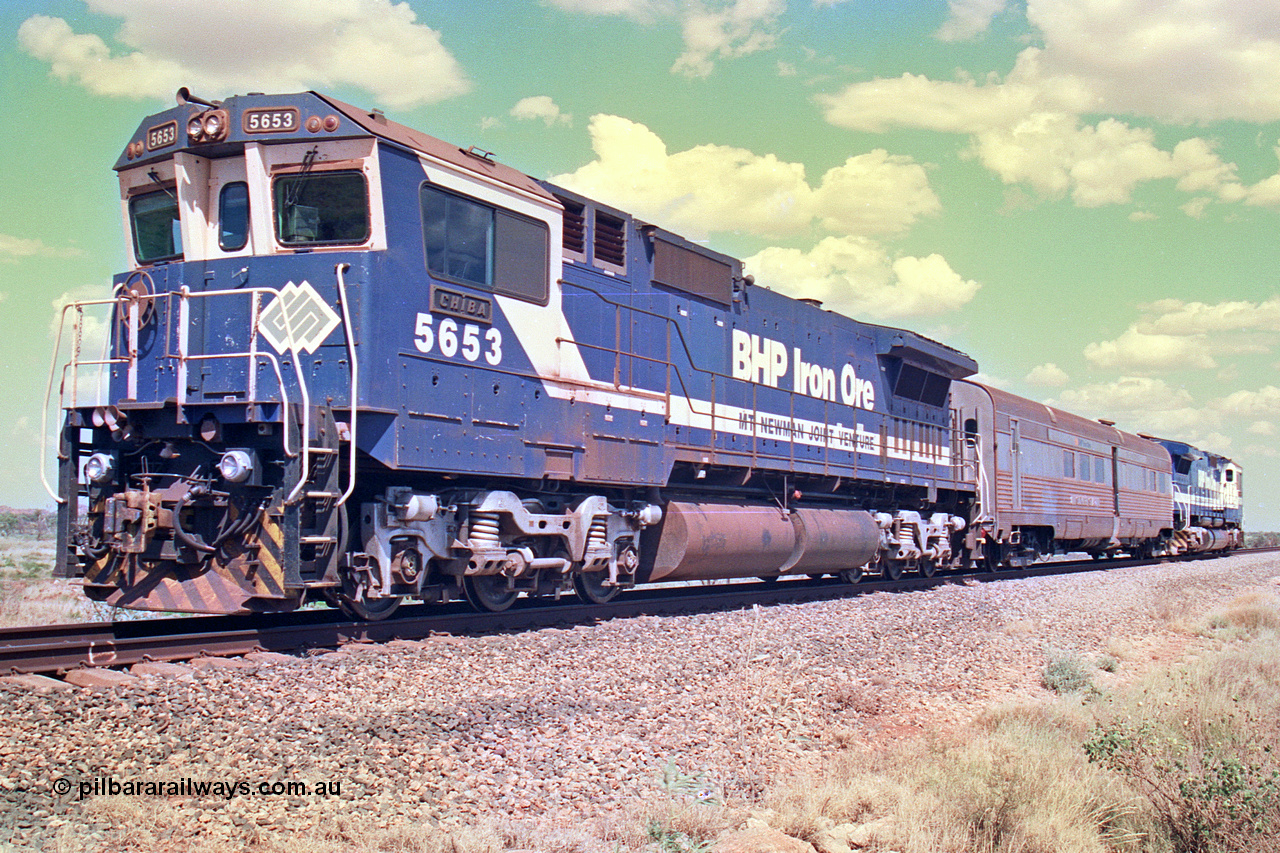 268-28
At the 39 km detection site with the Alstom 25-year service agreement special, BHP Iron Ore's Goninan GE rebuild CM40-8M unit 5653 'Chiba' serial number 8412-10 / 93-144 stands on the Newman mainline with The Sundowner and 5634 on the rear of the train as the party conducts an inspection of the site. Friday 12th of April 2002.
Keywords: 5653;Goninan;GE;CM40-8M;8412-10/93-144;rebuild;AE-Goodwin;ALCo;M636C;5484;G6061-5;