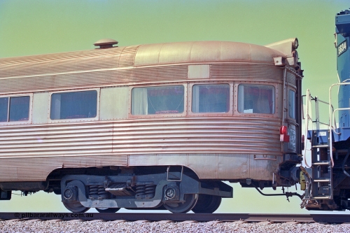 268-31
At the 39 km detection site with the Alstom 25-year special, the Sundowner coach, originally built by E. G. Budd in 1939 numbered 301 as the Silver Star, a diner-parlour-observation coach on the Chicago, Burlington and Quincy Railroad's General Pershing Zephyr train from the 1930s and 1940s. Donated to Mt Newman Mining Co. by AMAX an original joint venture partner to commemorate the projects first 100 million tonnes of iron ore railed between Mount Whaleback mine and the Port Hedland port. April 12, 2002.
Keywords: Silver-Star;EG-Budd;Sundowner;General-Pershing-Zephyr;301;