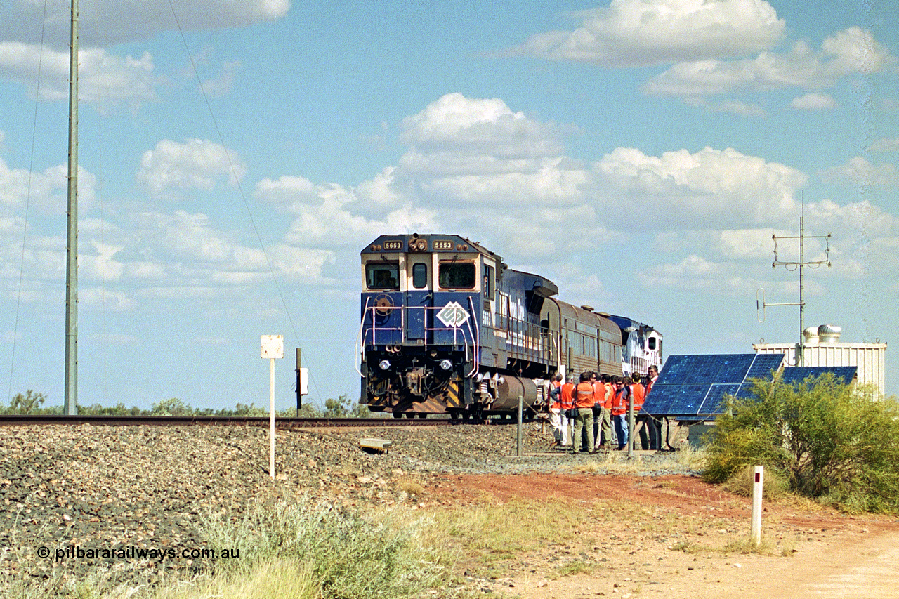 269-01
At the 39 km detection site with the Alstom 25-year service agreement special, BHP Iron Ore's Goninan GE rebuild CM40-8M unit 5653 'Chiba' serial number 8412-10 / 93-144 stands on the Newman mainline with The Sundowner and 5634 on the rear of the train as the party conducts an inspection of the site. Friday 12th of April 2002.
Keywords: 5653;Goninan;GE;CM40-8M;8412-10/93-144;rebuild;AE-Goodwin;ALCo;M636C;5484;G6061-5;