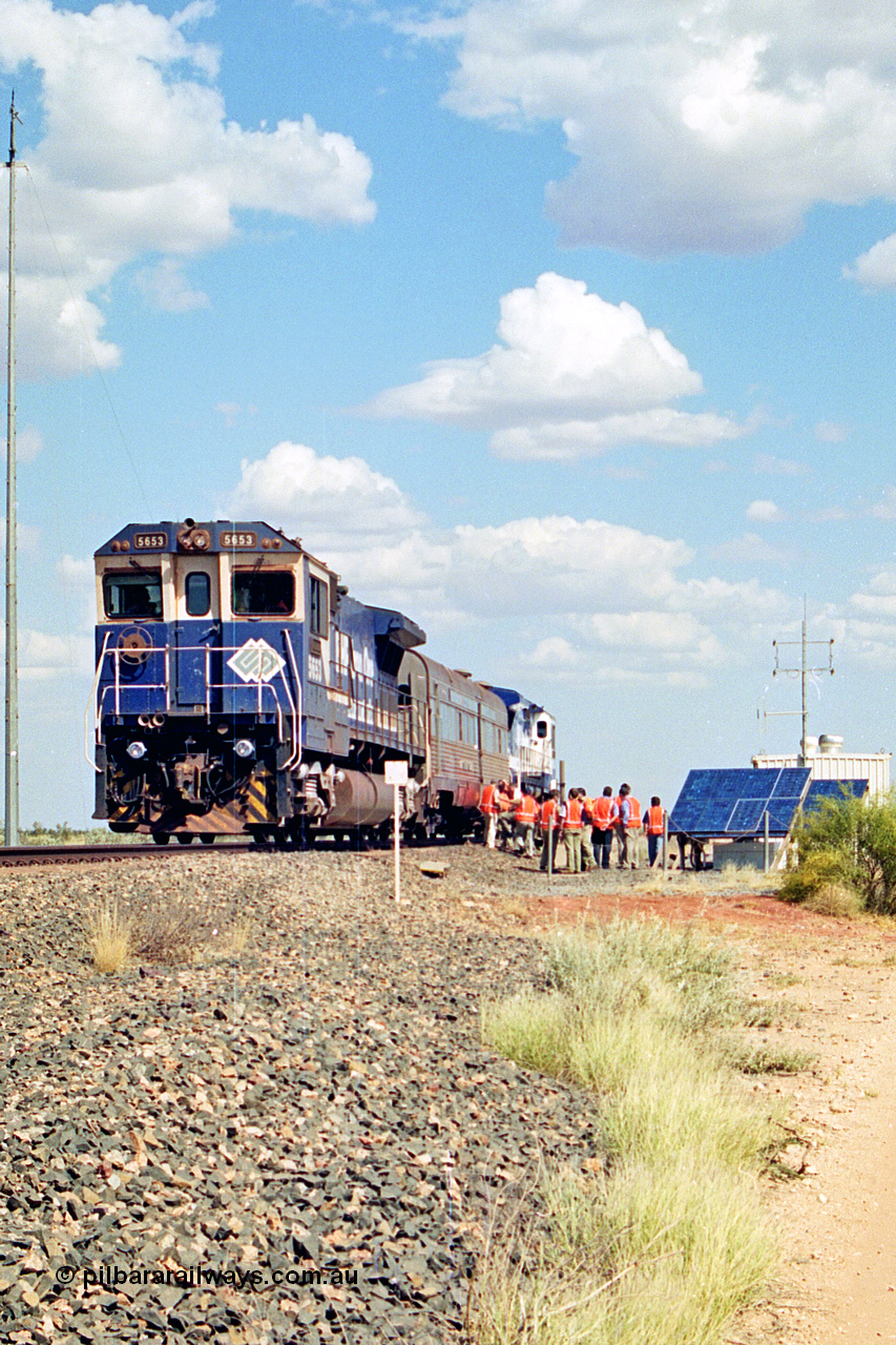 269-07
At the 39 km detection site with the Alstom 25-year service agreement special, BHP Iron Ore's Goninan GE rebuild CM40-8M unit 5653 'Chiba' serial number 8412-10 / 93-144 stands on the Newman mainline with The Sundowner and 5634 on the rear of the train as the party conducts an inspection of the site. Friday 12th of April 2002.
Keywords: 5653;Goninan;GE;CM40-8M;8412-10/93-144;rebuild;AE-Goodwin;ALCo;M636C;5484;G6061-5;