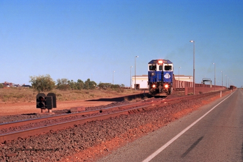 275-10
Boodarie, BHP Iron Ore's 5645 'Sherlock' departs the service road on its way to Yarrie with an empty, on the far left the HBI beneficiation plant is visible. The loaded is running down the mainline towards Finucane Island. This scene has changed immensely since August 10, 2003.
Keywords: 5645;Goninan;GE;CM40-8M;8281-11/92-134;rebuild;AE-Goodwin;ALCo;M636C;5475;G6047-7;