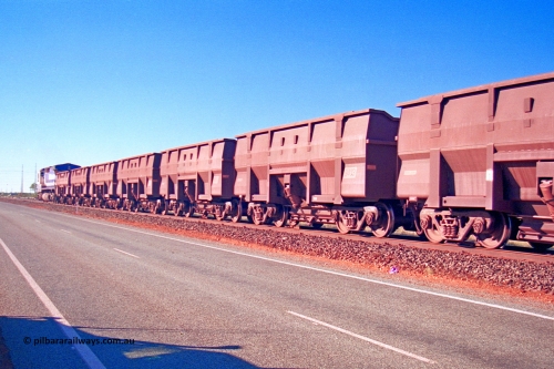 275-16
Boodarie, a rake of examples of the Goninan Golynx iron ore waggons, 8413 with serial number 950088-343, modified for bottom discharge to operate over the Finucane Island unloading hopper. August 10, 2003.
Keywords: 8413;Goninan;Golynx;950088-343;BHP/GML-ore-waggon;