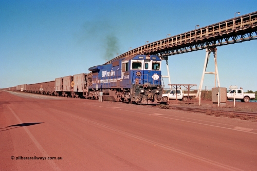 275-19
Finucane Island, BHP Iron Ore's CM40-8 locomotive 5646 'White Springs' arrives at the island across the -0.8 km grade crossing and the No. 6 switch where the balloon loops rejoins the mainline. The elevated conveyor is for the HBI plant. August 10, 2003.
Keywords: 5646;Goninan;GE;CM40-8;8244-11/92-135;